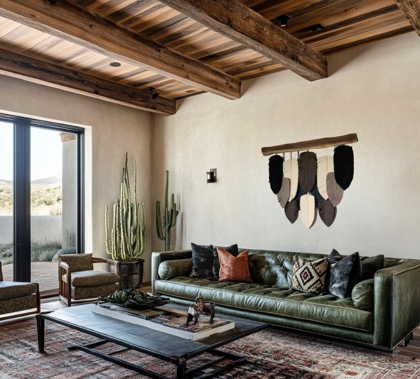 A wall hanging decor featuring a series of handcrafted macramé leaves in shades of beige, brown, and black, strung together on a wooden plank.